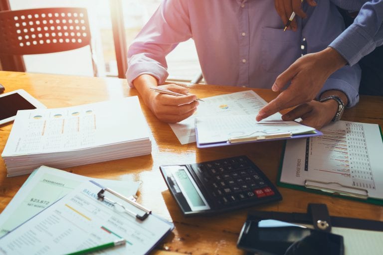 Business man accountant working hard of accounting financial report of annual 2017 with tax paperwork or job order product.