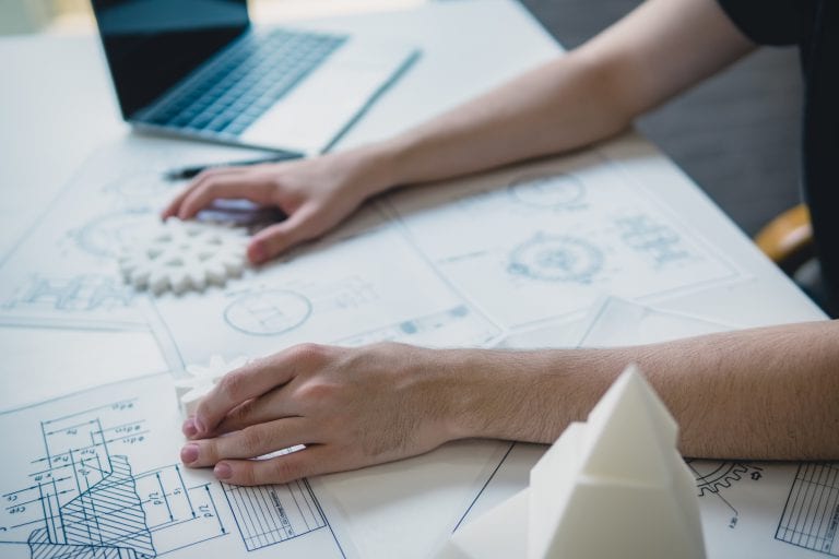 Engineering man's hand working with 3D printer's components and blueprint for designing mechanical parts . Engineering tools and  technology concept.