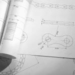 Part blueprints on engineer's workplace