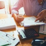 Business man accountant working hard of accounting financial report of annual 2017 with tax paperwork or job order product.