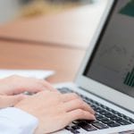 Closeup banner website work with finance analysis and planing data on laptop, typing and paper graph with computer statistic for success, business freelance concept.