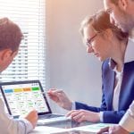 Daily team meeting around agile product development board with scrum or kanban framework, lean methodology, iterative or incremental organization project management strategy for software design